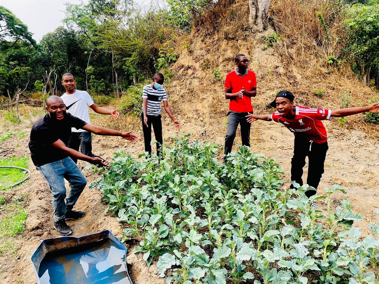 Libarti Boys learners proudly presenting crops in the school vegetable garden