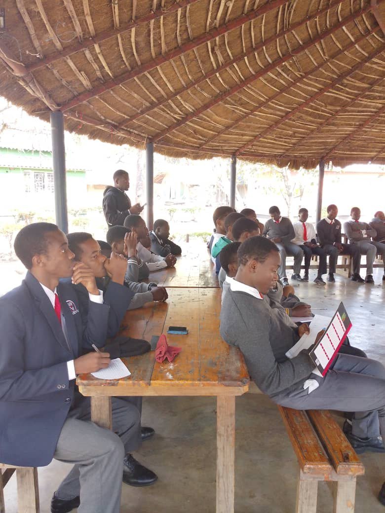 Libarti Boys students listening and taking notes during a Chimfunshi briefing