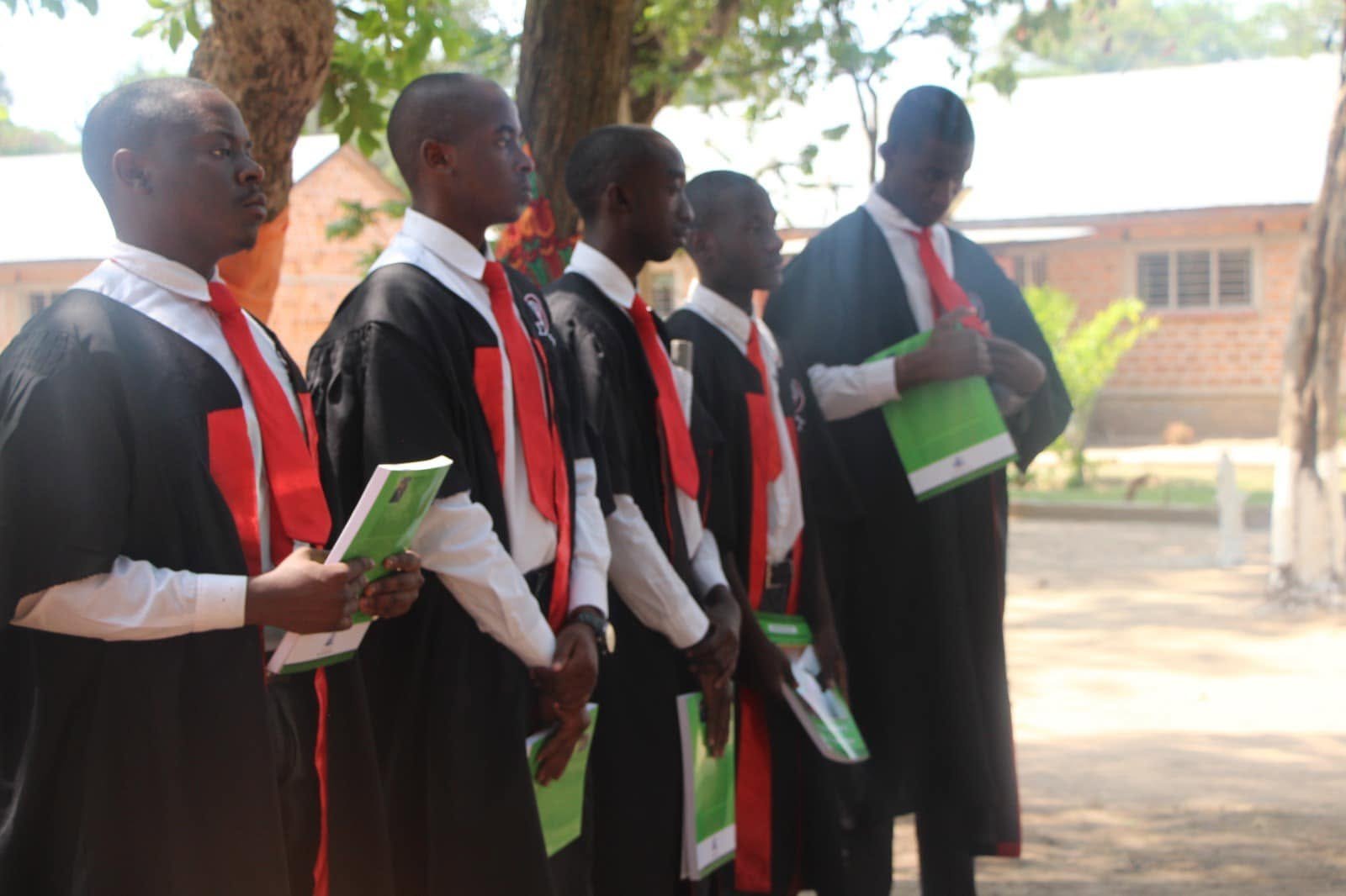 Libarti Boys graduands in ceremonial gowns gathered on campus